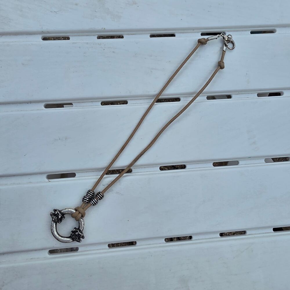 beige leather cord necklace with a silver-tone ring pendant